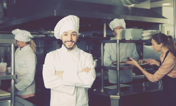 istock Adult chef of restaurant posing in kitchen 1051171900