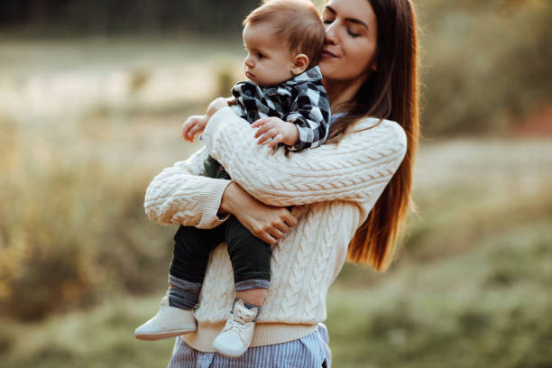 istock Mother holding his son in forest in sunset 1051171904