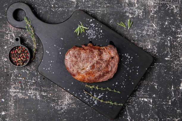 beef steak with thyme and rosemary stock photo