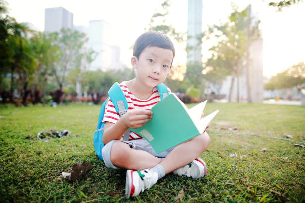 istock Boy outdoor with books 1051176406