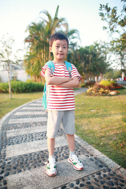 istock Boy outdoor with books 1051176866