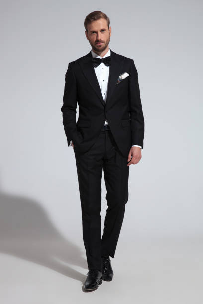 istock young elegant groom stepping forward with hand in pocket 1051179768