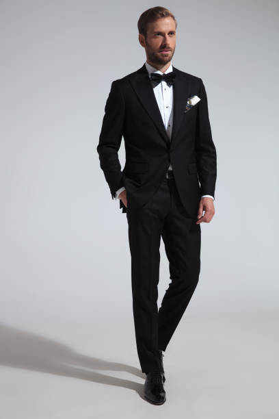 istock elegant man in tuxedo standing with hand in pocket 1051179848