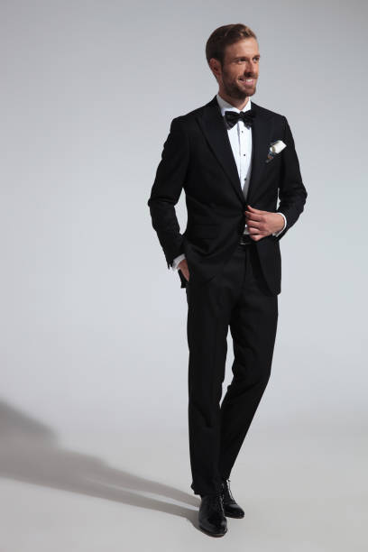 istock side view of a r man in tuxedo holding his button 1051179870