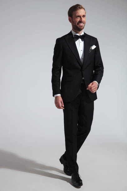 istock smiling young elegant man walks in his tuxedo 1051179898