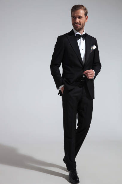 istock elegant man with hand in pocket walking and looking away 1051179932