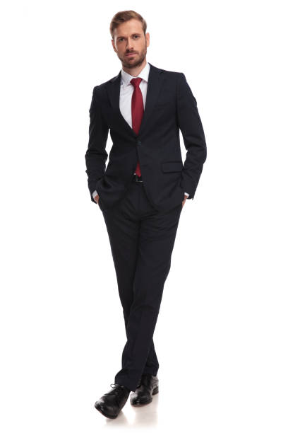 istock relaxed businessman standing with hands in pockets and legs crossed 1051180332
