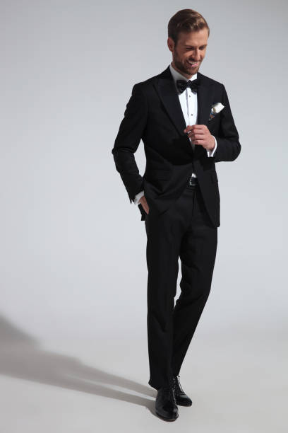 istock relaxed elegant man in tuxedo is laughing 1051181364