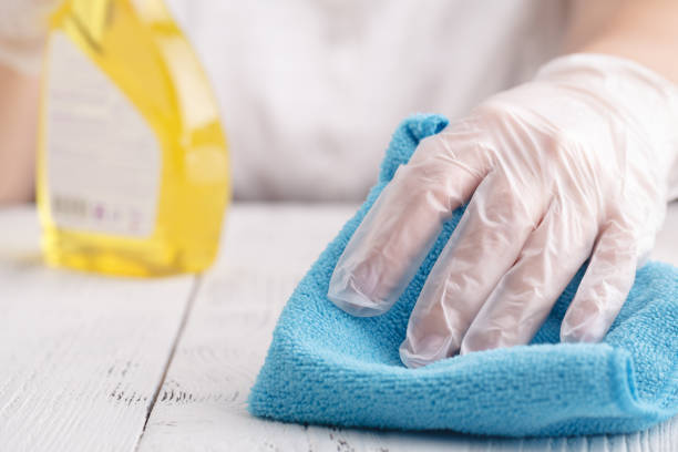 istock Hand in a protective glove with a washing sponge and spray sprinkle 1051185656