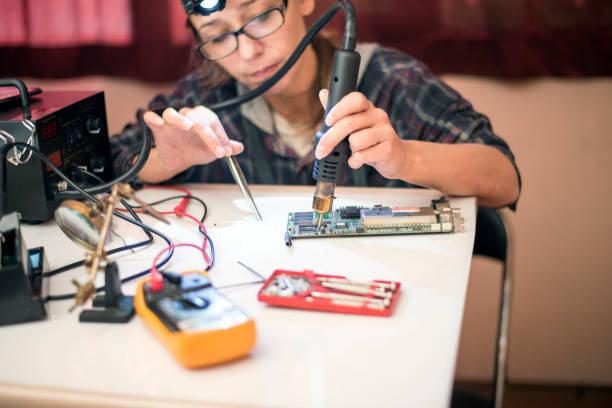 istock Woman Soldering a circuit board 1051190124