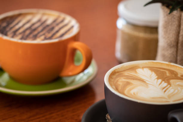 istock Latte and cappuccino or mocha coffees on a table in a cafe setting 1051191752