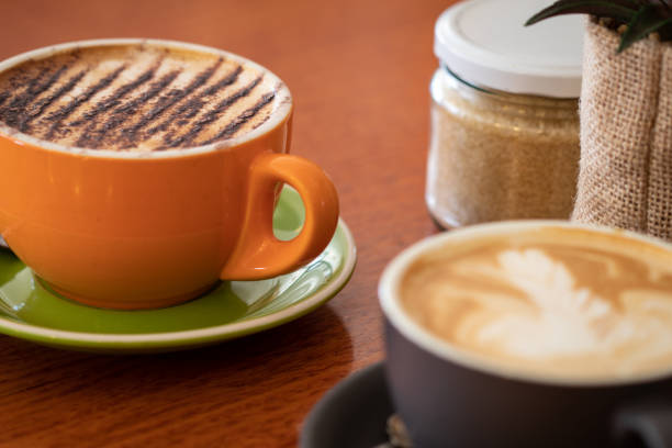 istock Latte and cappuccino or mocha coffees on a table in a cafe setting 1051191818
