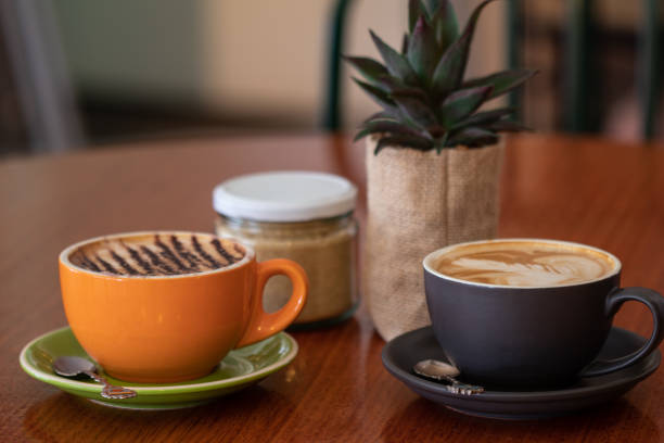Latte and cappuccino or mocha coffees on a table in a cafe setting