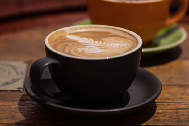 istock Latte and cappuccino or mocha coffees on a table in a cafe setting 1051191928