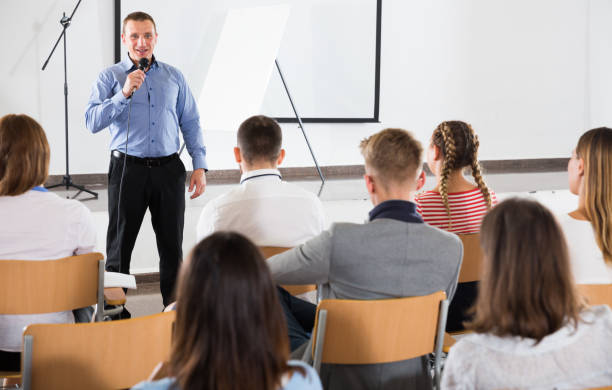 istock Male professor delivering speech to students 1051193128