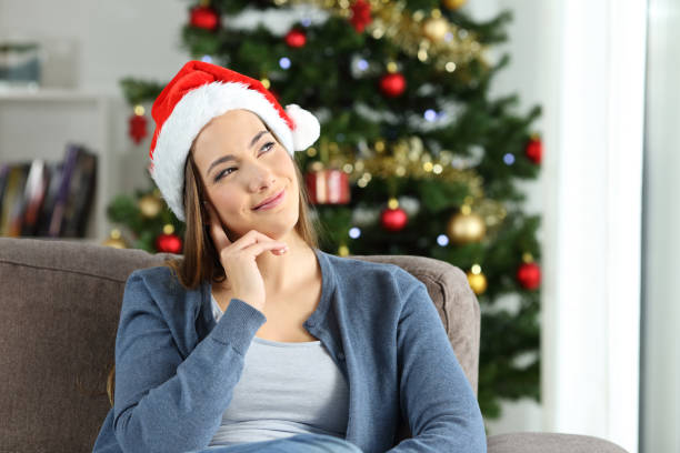 istock Woman thinking looking at side at home in christmas 1051194878