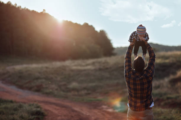 istock Father throwing son into air 1051195602