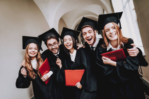 Diploma. University.Students. Friendship. Mantles. Diploma. University. Students. Mantles. Friendship. Group of Students. Standing. Corridor. University. Young People. Freelance. Knowledge. Architecture. Study Together. Good Mood. Have Fun. alumni stock pictures, royalty-free photos & images