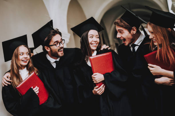 istock Group of Students. Diploma. Mantles. Standing. 1051195778