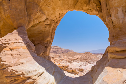 The big natural rock arch formation and desert view in Timna National Park, Israel.