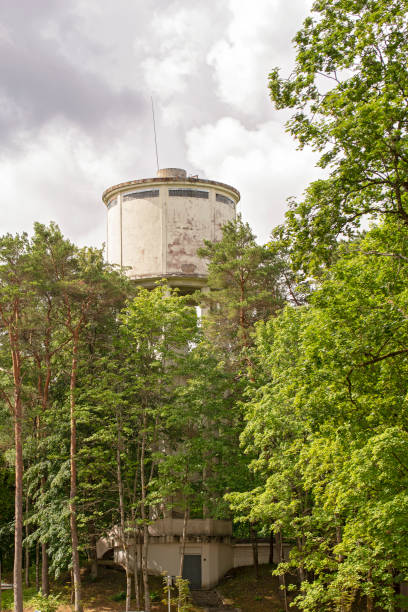 istock Abandoned brick tower in the green woods 1051201348
