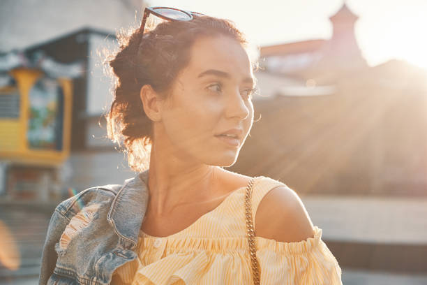 Young woman at sunset portrait with sunlight. stock photo