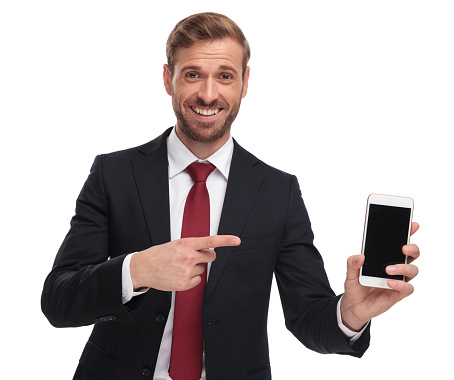 portrait of happy businessman pointing at mobile phone screen
