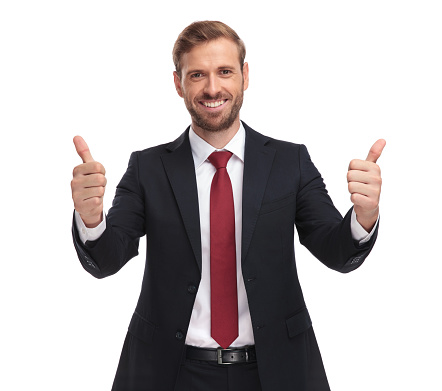 portrait of excited young businessman making thumbs up sign