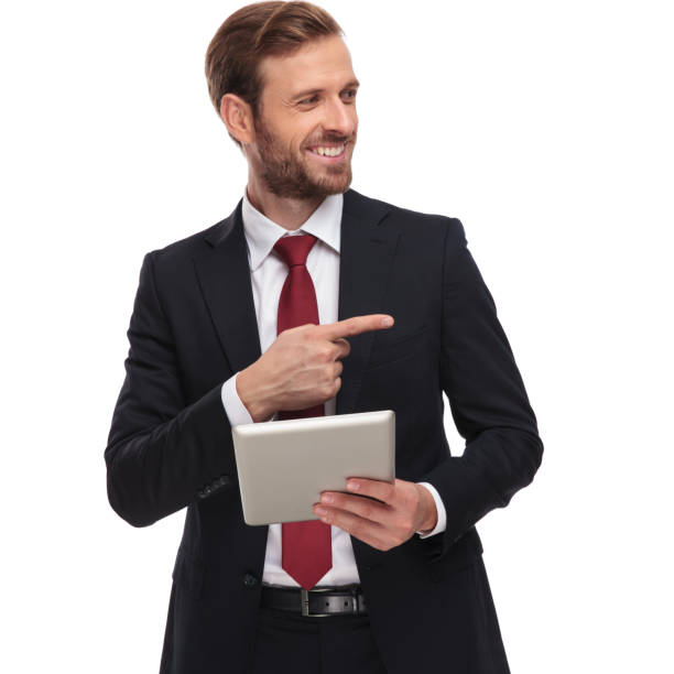 istock curious businessman with tablet looks and points to side 1051207184