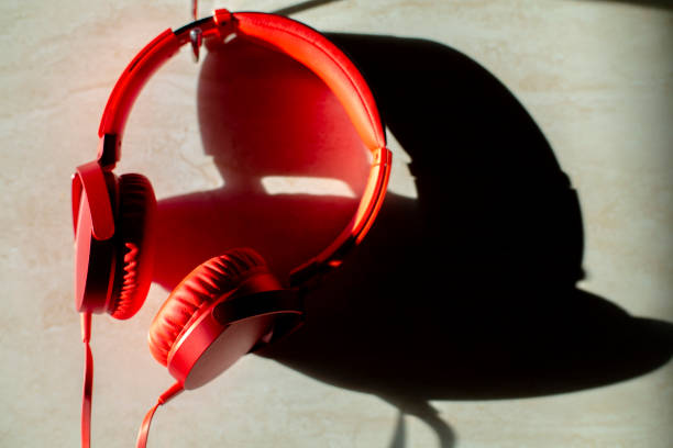 istock headphones hanging on wall with shadow by sunlight 1051207198