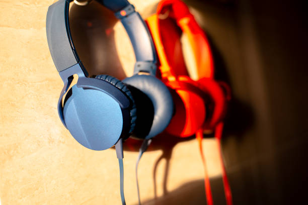 istock headphones hanging on wall with shadow by sunlight 1051207262
