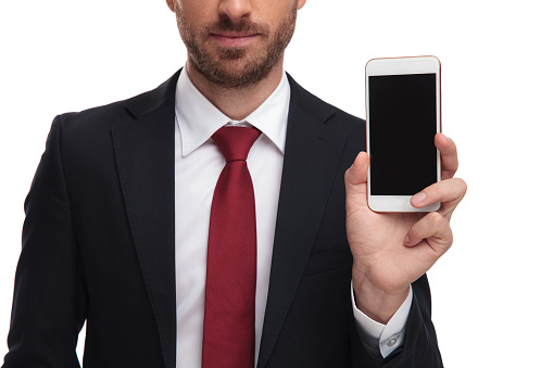 close up of body of businessman presenting mobile phone