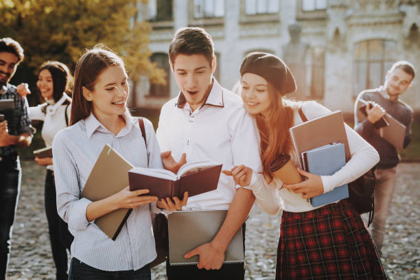 istock Holding Books. Two Girls and Boy . Knowledge. 1051211542