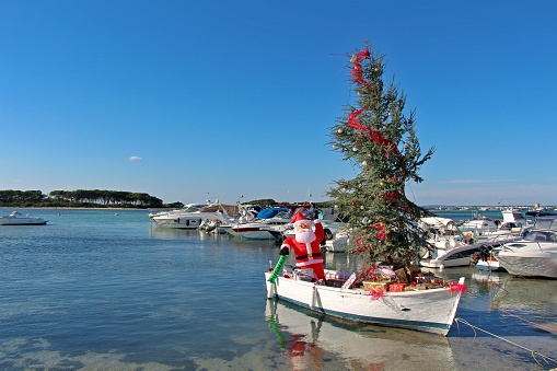 In the south of Italy, Santa Claus does not come from the sky, but from the sea! (Porto Cesareo, Apulia, Italy. December 31, 2016)