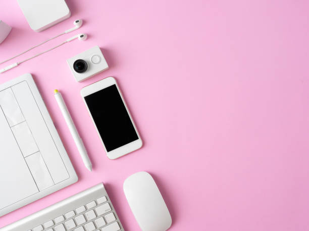 istock top view of office desk workspace with smartphone, notebook, graphic tablet, keyboard and mouse on pink color background, graphic designer, Creative Designer concept. 1051224804