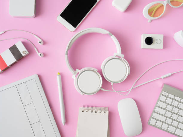 istock top view of office desk workspace with smartphone, notebook, graphic tablet, keyboard and mouse on pink color background, graphic designer, Creative Designer concept. 1051224932