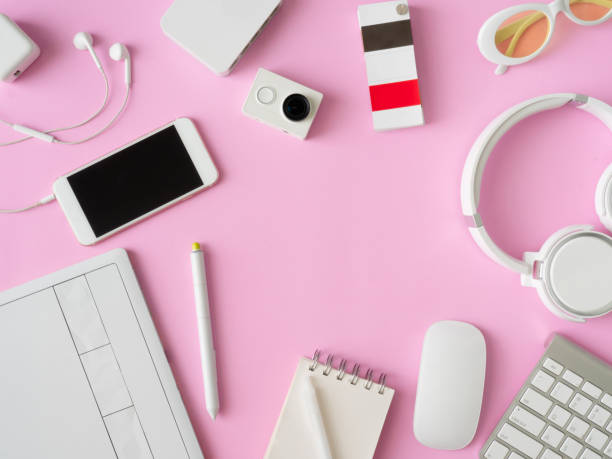 istock top view of office desk workspace with smartphone, notebook, graphic tablet, keyboard and mouse on pink color background, graphic designer, Creative Designer concept. 1051225030