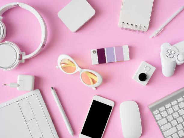istock top view of office desk workspace with smartphone, notebook, graphic tablet, keyboard and mouse on pink color background, graphic designer, Creative Designer concept. 1051225560
