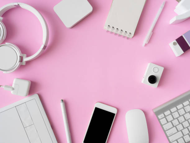 istock top view of office desk workspace with smartphone, notebook, graphic tablet, keyboard and mouse on pink color background, graphic designer, Creative Designer concept. 1051226148