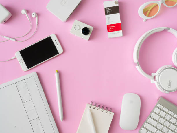 istock top view of office desk workspace with smartphone, notebook, graphic tablet, keyboard and mouse on pink color background, graphic designer, Creative Designer concept. 1051227056