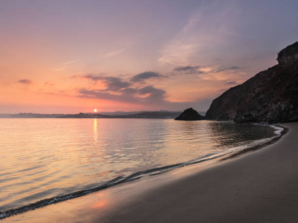 serene sunset, полкеррис-бич, корнуолл - tide rock bay landscape стоковые фото и изображения