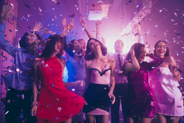 istock Sequins fall from violet ceiling, ecstatic, positivity, happiness, emotion, excited, rejoice persons dance make big toothy smile, raised hands up 1051228456