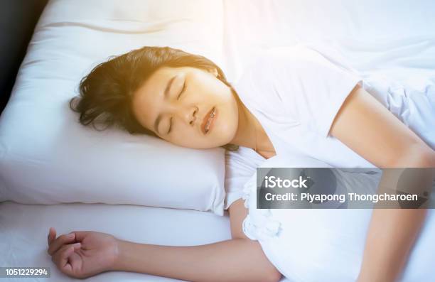 Women Sleeping On The Bed And Grinding Teethfemale Tiredness And Stress Stock Photo - Download Image Now