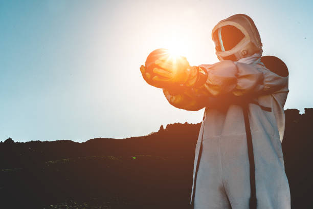 Spaceman holding earth planet after a nuclear attack - Astronaut travel in space - Saving the world, discovering new galaxy and future concept - Focus on him