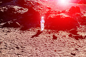 Astronaut discovering new red planet - Spaceman traveling universe looking for a new world to colonizing - Spacewalking and future concept - Focus on him