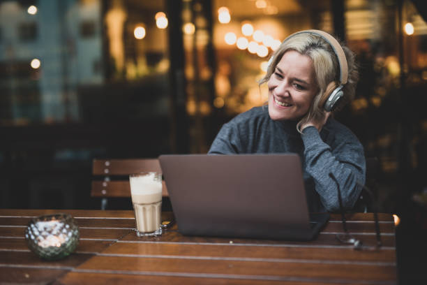 istock Woman using headphones to communicate via internet. 1051233576