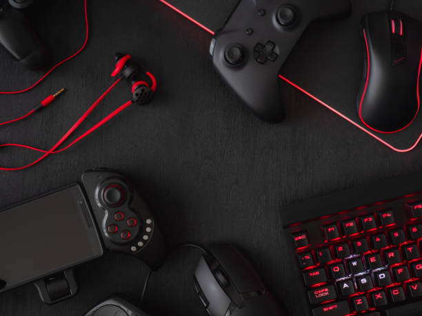 istock gamer workspace concept, top view a gaming gear, mouse, keyboard, joystick, headset, mobile joystick, in ear headphone and mouse pad on black table background. 1051243522