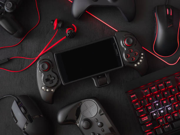 istock gamer workspace concept, top view a gaming gear, mouse, keyboard, joystick, headset, mobile joystick, in ear headphone and mouse pad on black table background. 1051243552