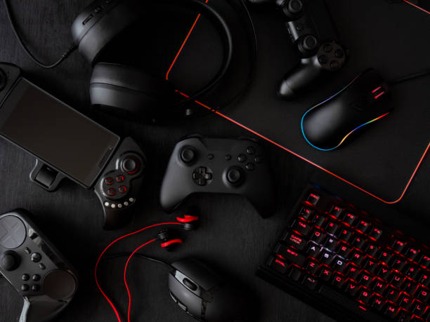 istock gamer workspace concept, top view a gaming gear, mouse, keyboard, joystick, headset, mobile joystick, in ear headphone and mouse pad on black table background. 1051243572