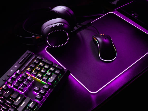istock gamer workspace concept, top view a gaming gear, mouse, keyboard, joystick, headset, mobile joystick, in ear headphone and mouse pad on black table background. 1051243584